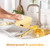 Yellow kitchen scale being washed under running tap