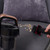 Corded vacuum cleaner with rose gold detail cleaning crumbs from grey sofa