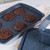 Tray of six chocolate cookies on blue speckled baking tray in kitchen