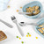 Children's silver cutlery set with animal motifs, showing fork, knife, spoon and teaspoon.