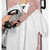 Steam iron in use on white shirt with rose gold ironing board and sleeve board