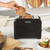 Black Salter toaster on kitchen counter with bagel being inserted, product in use.