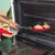 Red frying pan, metal handle, shown from base