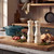Pair of cream Salter salt and pepper mills on a kitchen worktop with herbs and bread