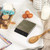 Glass bowl of fresh strawberries next to digital kitchen scales with three strawberries on top