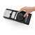 Black and silver mandoline slicer, hand shown using safety guard