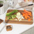 Rectangular wooden carving board with juice groove and textured centre