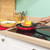 Red non-stick frying pan showing induction base