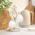 Four cream stoneware mugs on stand, with matching kettle, styled on kitchen worktop