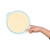 Hand holding pale blue mixing bowl of pancake batter on white background