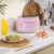 Pink two-slice toaster on kitchen counter with breakfast items, lifestyle setting