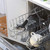Dishwasher rack with glass, mug, plate and black kitchen utensil for home appliances listing