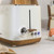 White toaster with wood-effect trim and controls, shown on a kitchen worktop