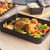 Large black non-stick roasting tray, rectangular, plain design, top view.