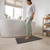 Charcoal bath mat in front of white tub, shown in bathroom setting