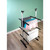 Three-tier metal clothes airer holding folded laundry in a modern indoor setting.