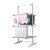 Three-tier grey indoor clothes airer with shirts and towels hanging