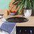 Black perforated pizza tray on kitchen worktop with towel