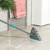 Grey triangular flip mop for floor cleaning, shown in packaging, single item.