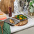 Set of two grey baking trays with food, shown on kitchen worktop