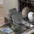 Grey baking trays and plates loaded in dishwasher rack