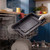 Black roasting tray being removed from dishwasher, highlighting easy cleaning feature.