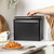 Black metal bread bin on kitchen counter, lid being lifted by hand