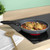 Non-stick frying pan with cooked chicken and vegetables on an induction hob