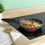Blue non-stick frying pan cooking chicken and vegetables on electric hob