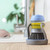 Kitchen soap dispensing brush with blue lid and base on wooden worktop