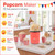 Red popcorn maker with 900W power, 50g capacity, lid bowl and measuring spoon