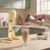 Yellow milkshake maker with glass of iced coffee being poured, on kitchen counter
