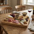 Charcuterie board with assorted cheeses, meats, crackers and figs on rustic table