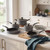 Grey non-stick saucepan and frying pan set on kitchen counter, lids included, shown in daylight