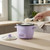 Small purple rice cooker with lid off, serving freshly cooked rice in a modern kitchen