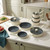 Cream cookware set with three saucepans, two frying pans, and two casserole dishes