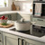 Cream casserole pot with lid on induction hob in modern kitchen