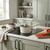 Cream saucepan with lid on induction hob in modern kitchen setting