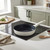 Cream non-stick frying pan on induction hob in modern kitchen