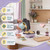 Purple waffle maker with batter being poured in and feature icons