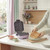 Purple waffle maker on kitchen counter with waffles and bowls of toppings