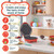 Mini waffle maker with non-stick plates and indicator lights, open on kitchen counter