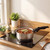 Stainless steel saucepan with black handle cooking stew on electric hob
