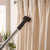 Vacuum cleaner brush cleaning cream curtains in living room