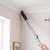 Vacuum cleaner nozzle cleaning white ceiling corner