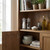 Salt and pepper mills, oil bottle and herbs on a wooden kitchen shelf