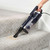 Handheld vacuum cleaning crumbs from carpeted stairs