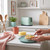 Lifestyle image of a green 2-slice toaster on a kitchen counter