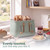 Mint green four-slice toaster with toast and breakfast items on kitchen counter