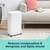 White dehumidifier in living room with text: reduces condensation, dampness and mould